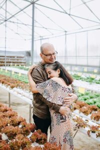 A man and a woman hugging in a garden because they feel better after having therapy for depression port jefferson new york 